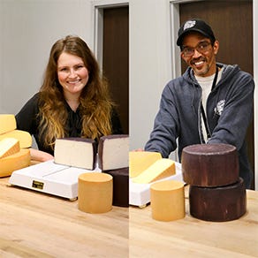 Image of Cheese Monger hand cutting cheese to order. 